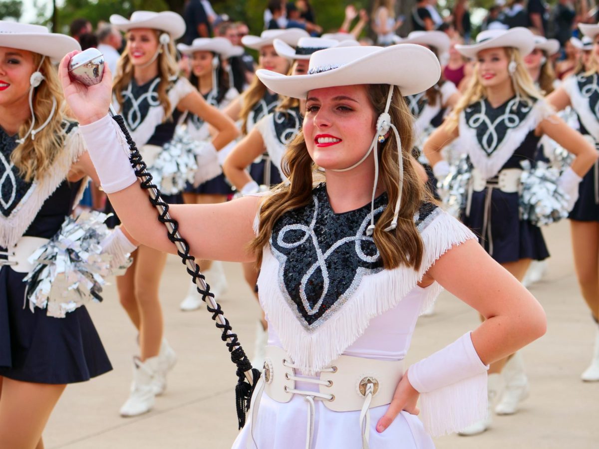 In the parade on Wednesday, Sept. 27, the Legacies walk the route amidst the floats before performing in the community pep rally.