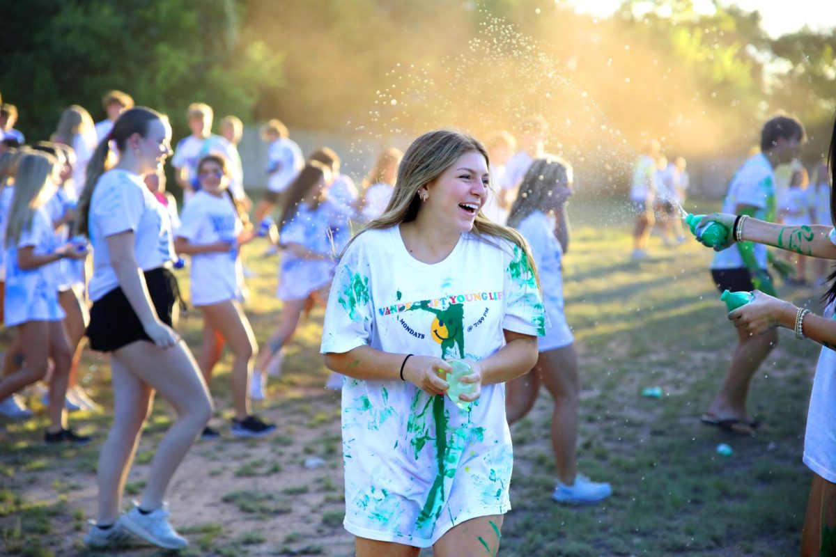 Junior Madeline Bischoff laughs as she participates in YoungLife festivities with her friends. YoungLife hosted the Color Wars to begin their meetings for the year. "I enjoy being in a community with all my friends and having fun with people who love God," Bischoff said. "The events are a lot of fun to participate in and Color Wars is a great way to start off the year."
