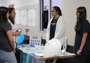 Senior Anvitha Kandula talks with parents and students, representing DECA at Open House in August. Kandula was one of 18 Vipers named a National Merit Semifinalist.