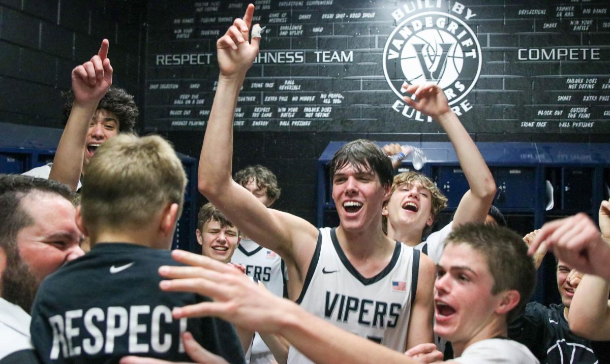 Along with the rest of the varsity boys team, senior center Trent Workman celebrates with Head Coach Jaime Sierra and his kids in the locker room after the historic 48-45 win over Westlake. “Coach Sierra, if you know him, you know he really doesn’t like to mess around. He’s a good coach. I’d say one of the better coaches in the state of Texas,” freshman guard Dylan Cottier said. “He’s a great guy but doesn’t really take stuff lightly. He takes his job seriously, and having a coach like that is good because it leads to winning. He’s hard on everybody, and it’s important for coaches to do that, and he’s definitely done that with me a few times. He’s done that with a lot of guys.”