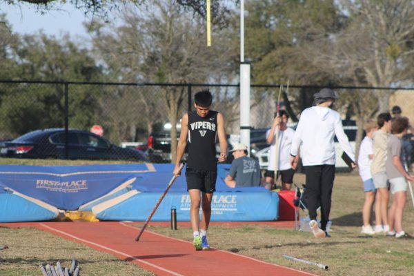 Varsity senior Philip Lou prepares to vault.